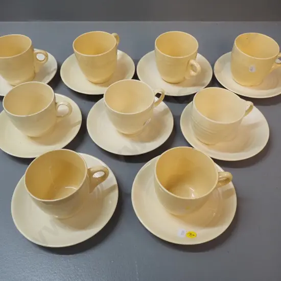 9 early Crown Lynn cups & saucers, varying shades of yellow, 2 cups have chips
