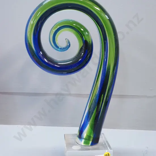 art glass blue & green koru on clear base, label reads The New Zealand Collection - Limited Edition H380
