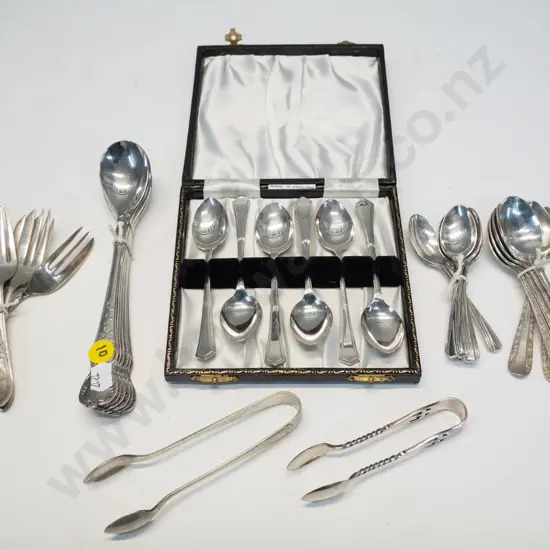 assorted plated teaspoons, cake forks, sugar tongs