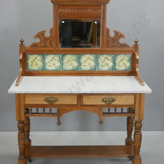 vintage kauri wash-stand with marble top, tiles and bevelled mirror in carved upstand, 2 drawers w/mottled fronts & drop