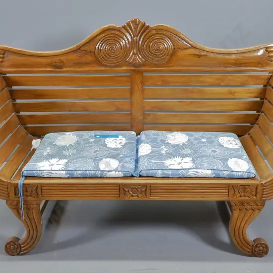 asian  ornately carved teak settee with scroll arms, loose seat cushion H940 W1480 D560