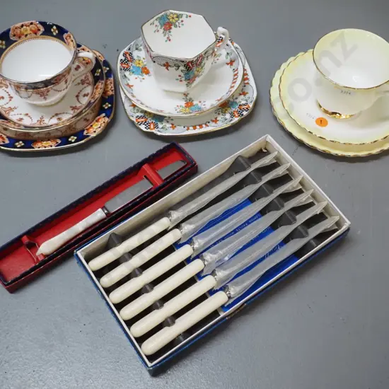 3 Royal Albert trios, boxed set of small bone-handled knives & a boxed small mother of pearl handled knife