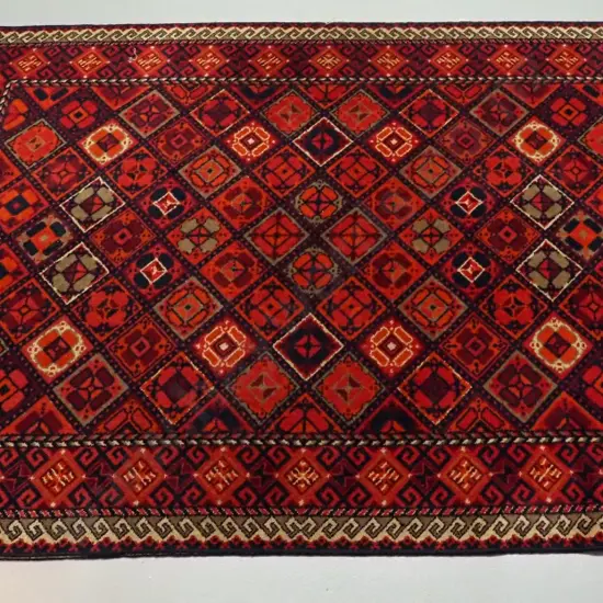 red geometric wool floor rug - wear to edges L-2530 W-1640