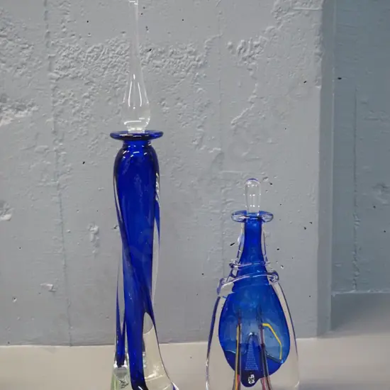2 art glass blue and clear stoppered bottles - smaller one with decoration signed (Peter) "Viesnik '97" - larger is H420