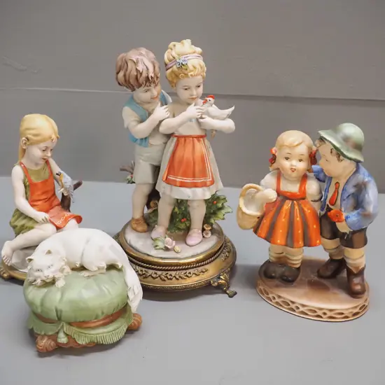 4 porcelain figurines: (Hummel ?) boy & girl, and 3 Italian items - Capodimonte cat, girl with bird, and boy & girl