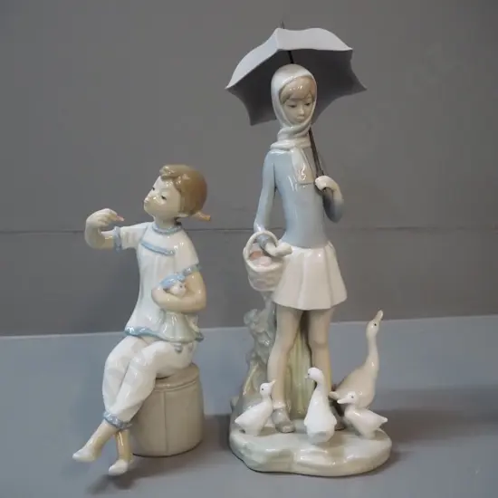 2 Lladro figures -  girl with umbrella and ducks H-280 and a girl with doll and lipstick