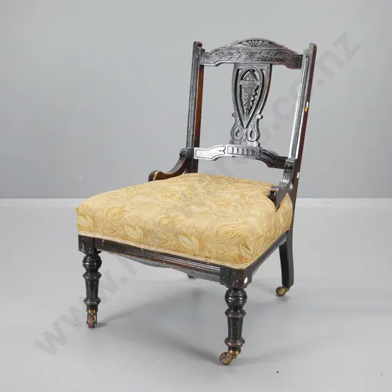 Edwardian dark-stained timber nursing chair w/gold patterned brocade, porcelain casters, rubbing to polish H800