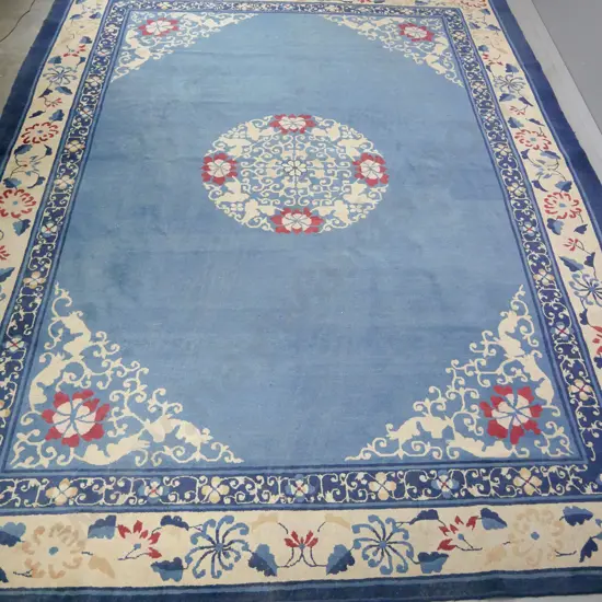 large Chinese wool floor rug - blue, cream and red floral motifs. Wear to edges. L-3490 W-2780