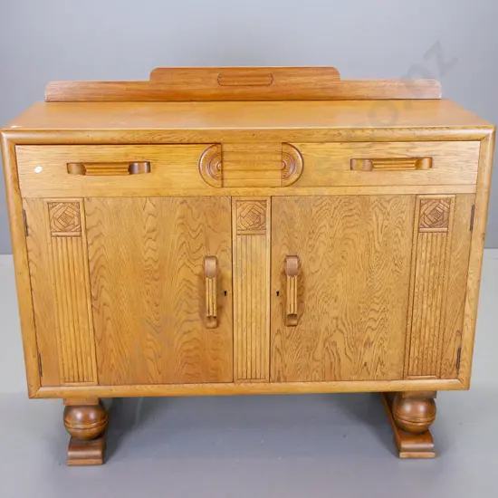 deco oak sideboard with 2 doors, 2 drawers, carved stylized rose motifs, large ball feet H-1030 W-1215 D-590