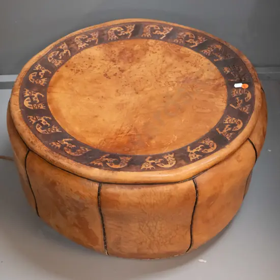 middle eastern leather pouffe with embossed pattern top, one side handle, aged finish H-280 D-540
