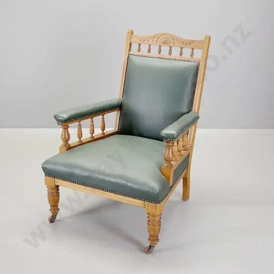Edwardian kauri armchair with spindle and carved back rail, covered in studded green leather H-950 W-680 D-730