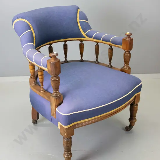 Edwardian mahogany spindle-back tub chair covered in plain weave fabric w/gold corded highlighting, on porcelain casters