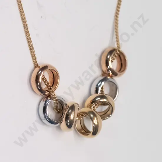 gold necklace with 7 rings stamped 375