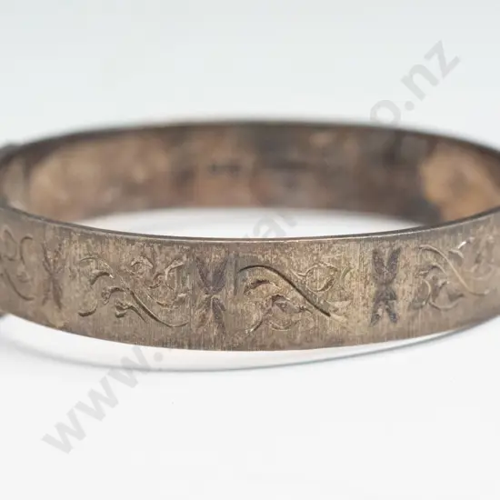 silver bangle with safety chain stamped with lion, X