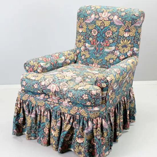 large high-backed rolled-arm chesterfield armchair covered in William Morris Strawberry Thief printed cotton