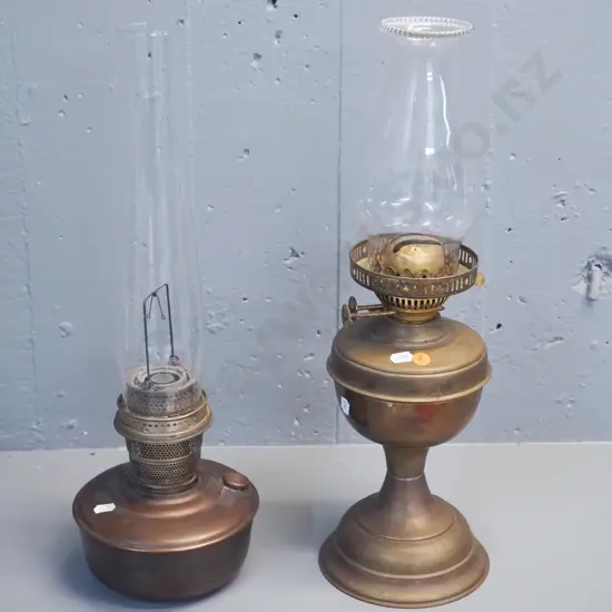 2 vintage kerosene lamps, one brass and one copper & brass, both with chimneys, one w/small chip to base H-480