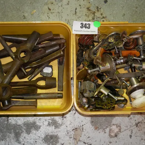 2 plastic tubs; various punches and cupboard door handles - green dots