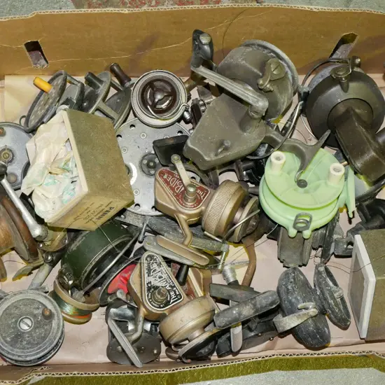 box of numerous vintage fishing reels