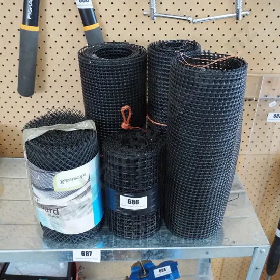 bundles of black plastic gutter guard