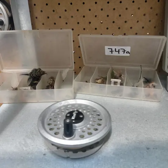 fly fishing reel and 2 containers of flies