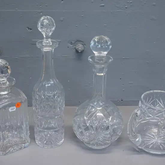 4 pieces cut crystal - 3 stoppered decanters and a water jug. Tallest decanter H-350, one stopper has chip to base