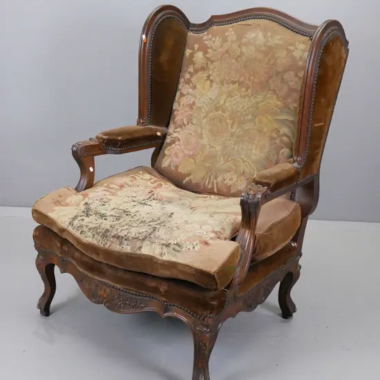 French fruit wood open armed wingchair, arms having entwined acanthus and bellflower decoration