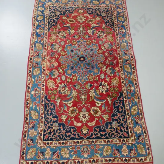 Iranian hand-knotted wool floor rug - red, blues and cream - foliate & floral motifs. Some wear & fading. L-1580 W-980