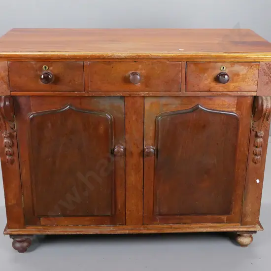 colonial dresser base in cedar having three top drawers above two shield cupboard doors,