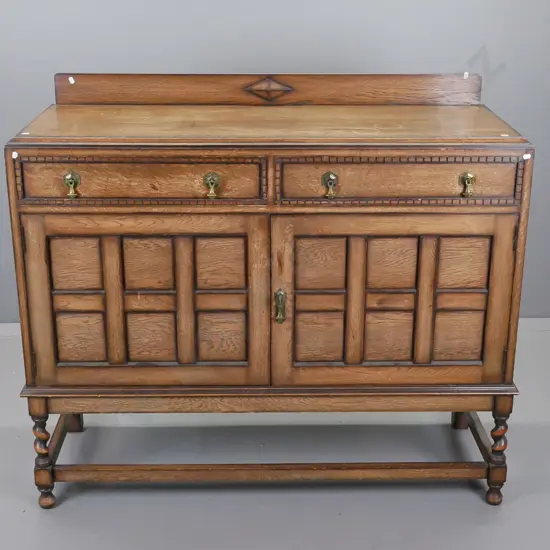 vintage oak sideboard, two drawers above two panel doors on stretcher base, surface fading,