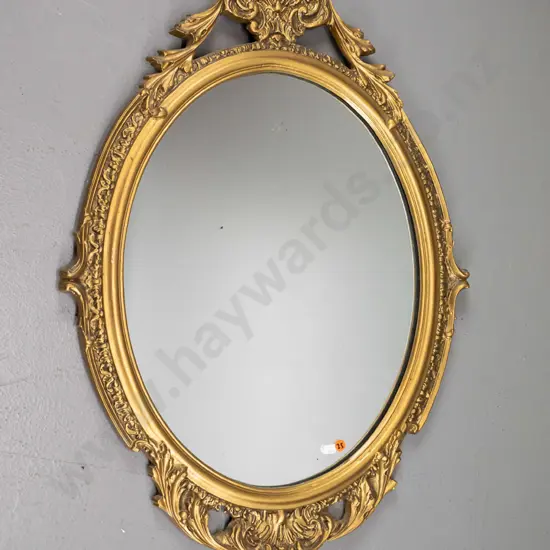 oval gilt cast metal framed wall mirror H-740 W-530 (slight silvering)