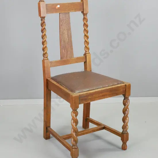 deco oak-framed dining chair with barley twist legs and back supports. Wear to brown leatherette seat. H-960 W-430 D-430