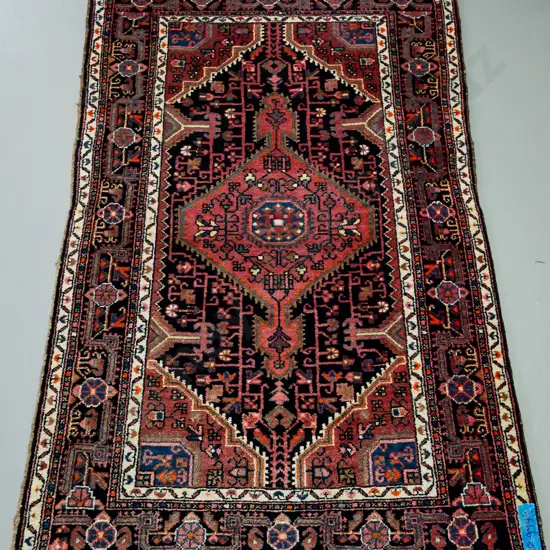 handknotted Iranian rug, in blue red ground, central geometric motif, geometric border L -1900 W- 1130