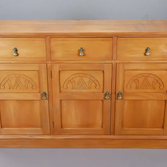 rimu entertainment unit in Edwardian style, brass drop handles, three carved panels in front