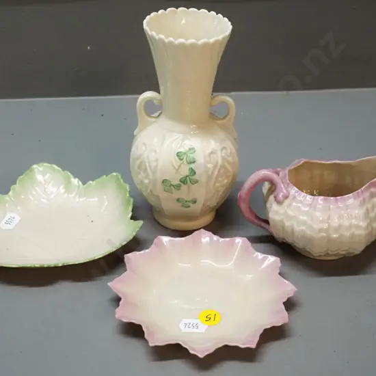 4 pieces of Belleek china, brown mark shamrock vase, black mark shell jug and 2 small plates