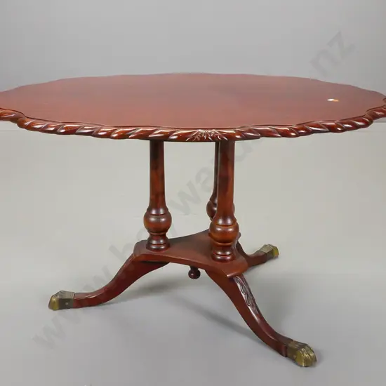 reproduction mahogany side table with scalloped shape top and rope edge on three turned columns