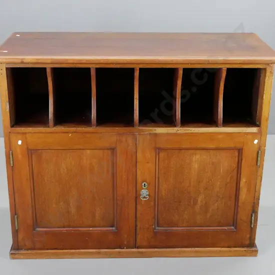 antique cedar(?) storage cabinet with open pigeonholes, 2 doors with brass drop handle, key escutcheon, no key - has