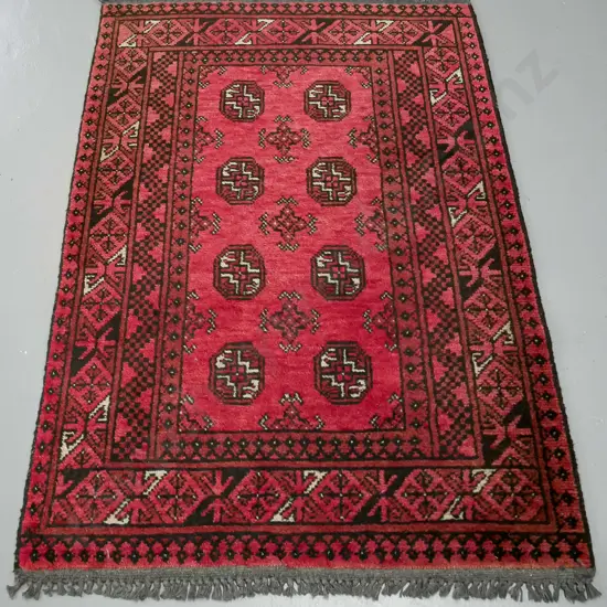 handknotted Turkoman rug, red ground, with central gul decoration and multiple geometric borders