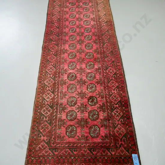handknotted Turkoman red ground runner, central panel of guls, multiple borders with diamond decoration