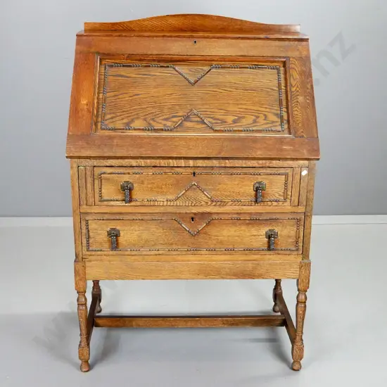 deco oak drop-front writing desk with 2 drawers, internal partitions, metal drop handles, decorative beading. No key,