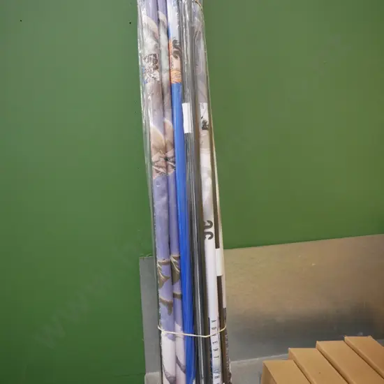 bundle of wall hanging prints on scrolls