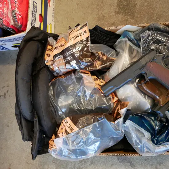 box of SWAT costume items - vests, masks, badges, gloves, guns