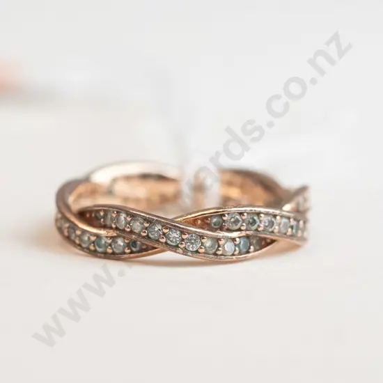 Small rose gold ring with small stones on the outer edge