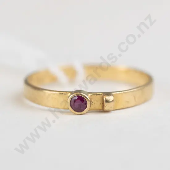 Gold colour ring with red stone
