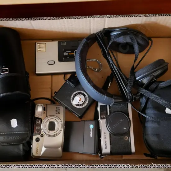 box; 35mm film cameras, disc camera, head phones, lens case