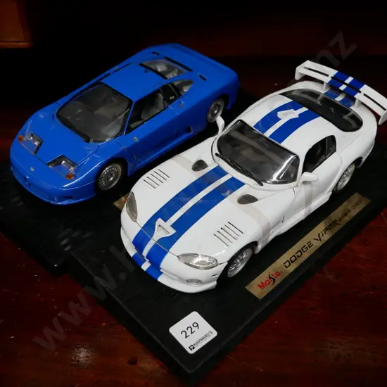2 model vehicles on stands, Dodge Viper and Bugatti
