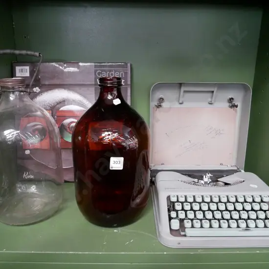 2 glass bottles, wall art, and Hermes portable typewriter
