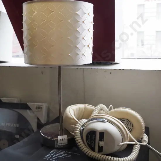 contemporary table lamp and pair of headphones