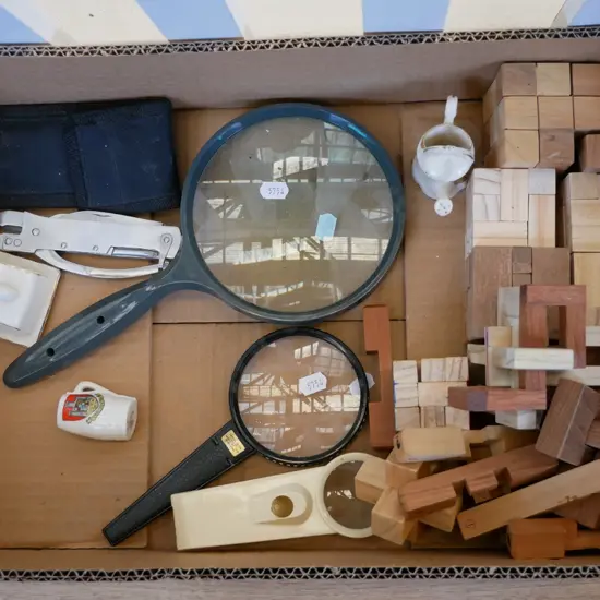 box; wooden puzzles, magnifying glasses etc