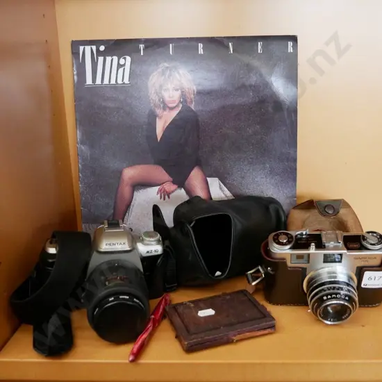 35 mm camera, Tina Turner album, small protractor set