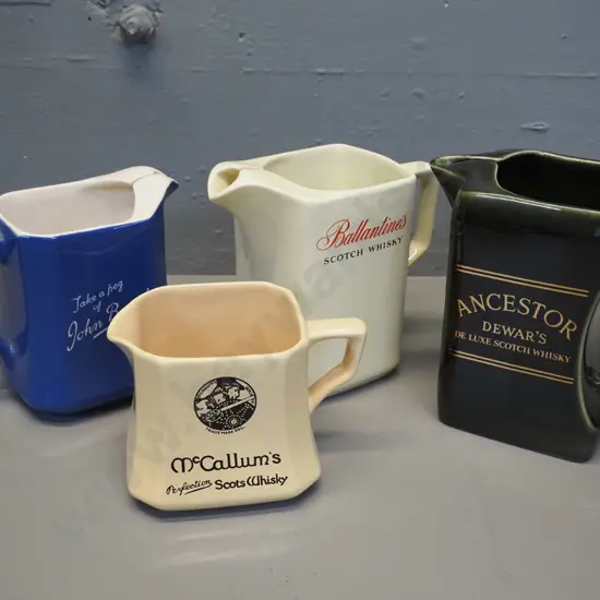 4 Scotch whisky water jugs all made by Wade. Tallest is H150